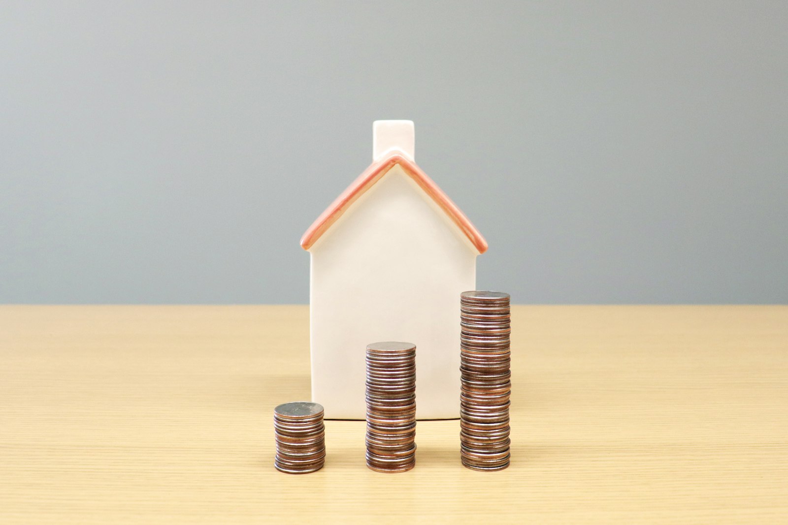 house model with stacked coins representing rental yield