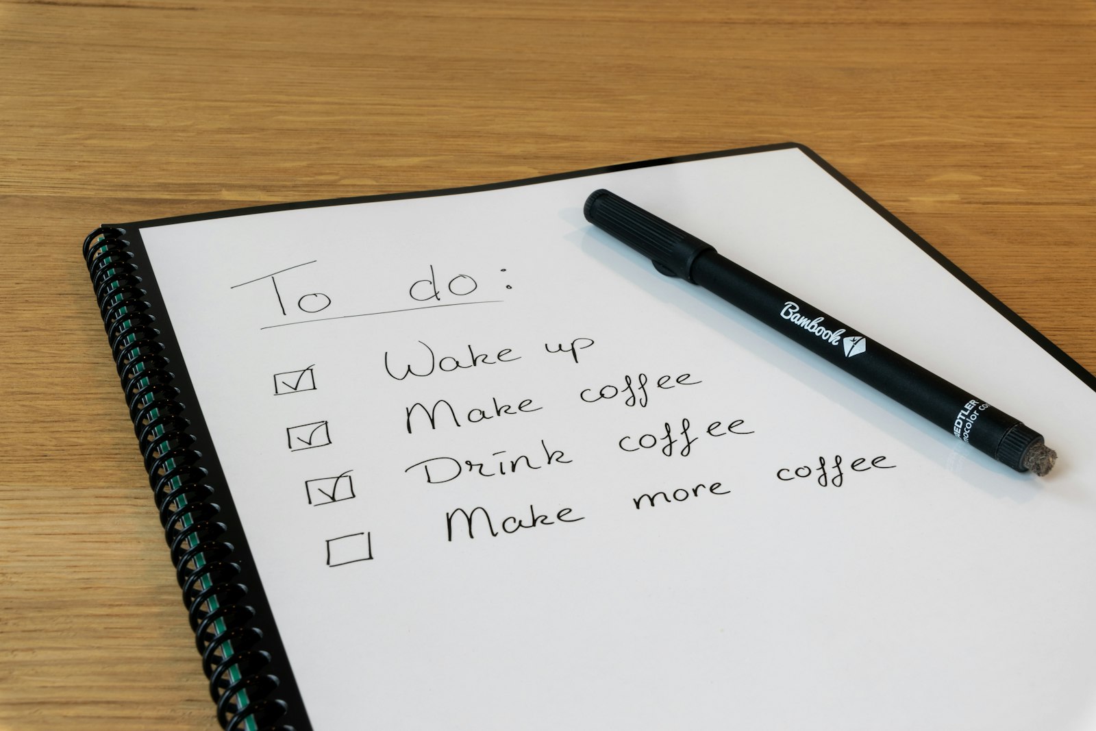 a notepad with a pen resting on top of it
