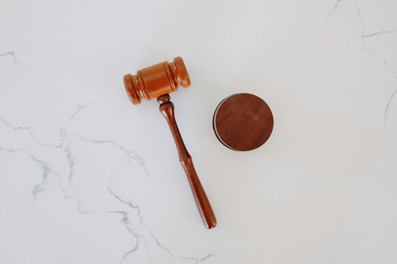 a wooden gavel and block resting on marble