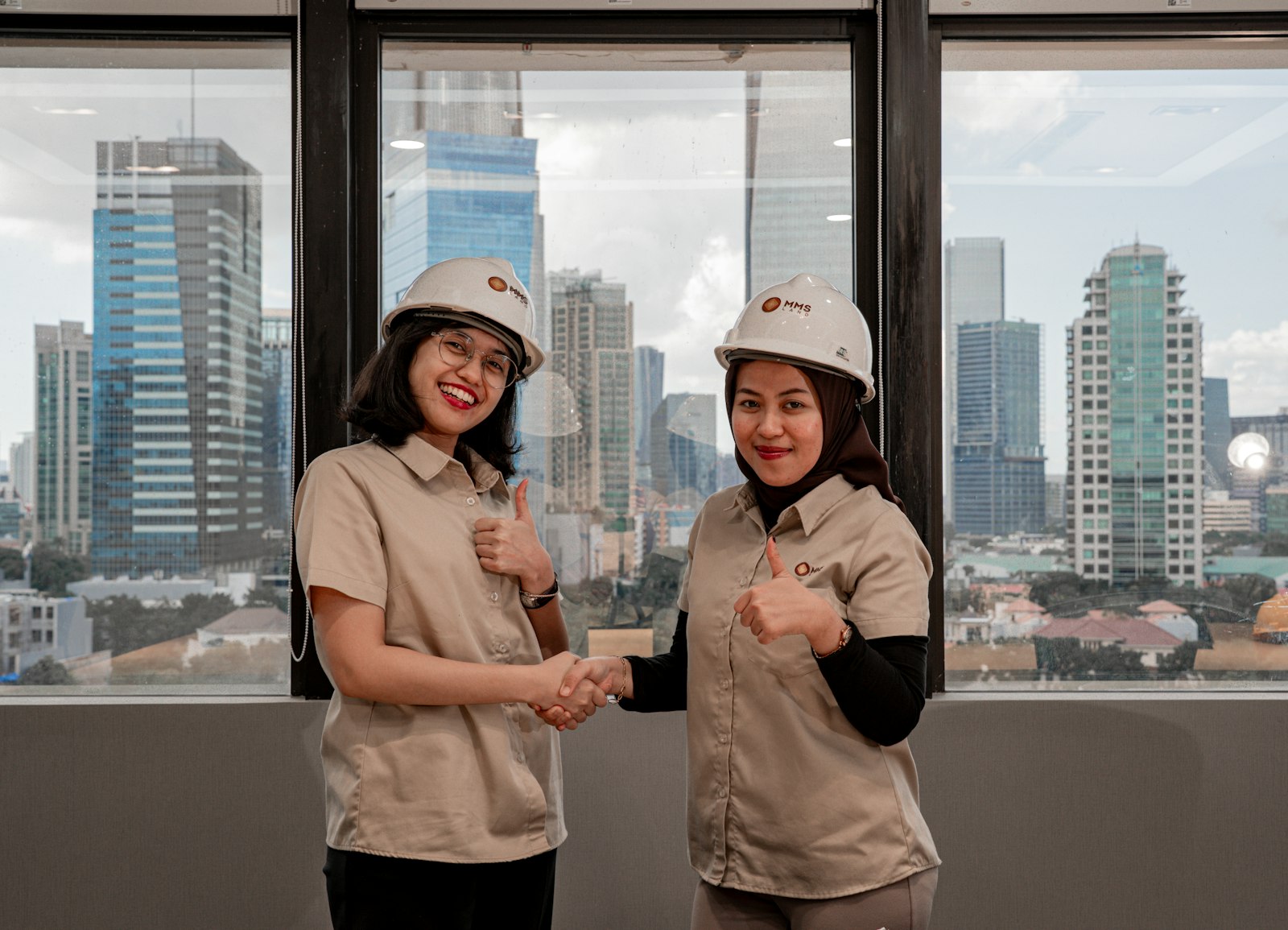 two people shaking hands with a city skyline behind them