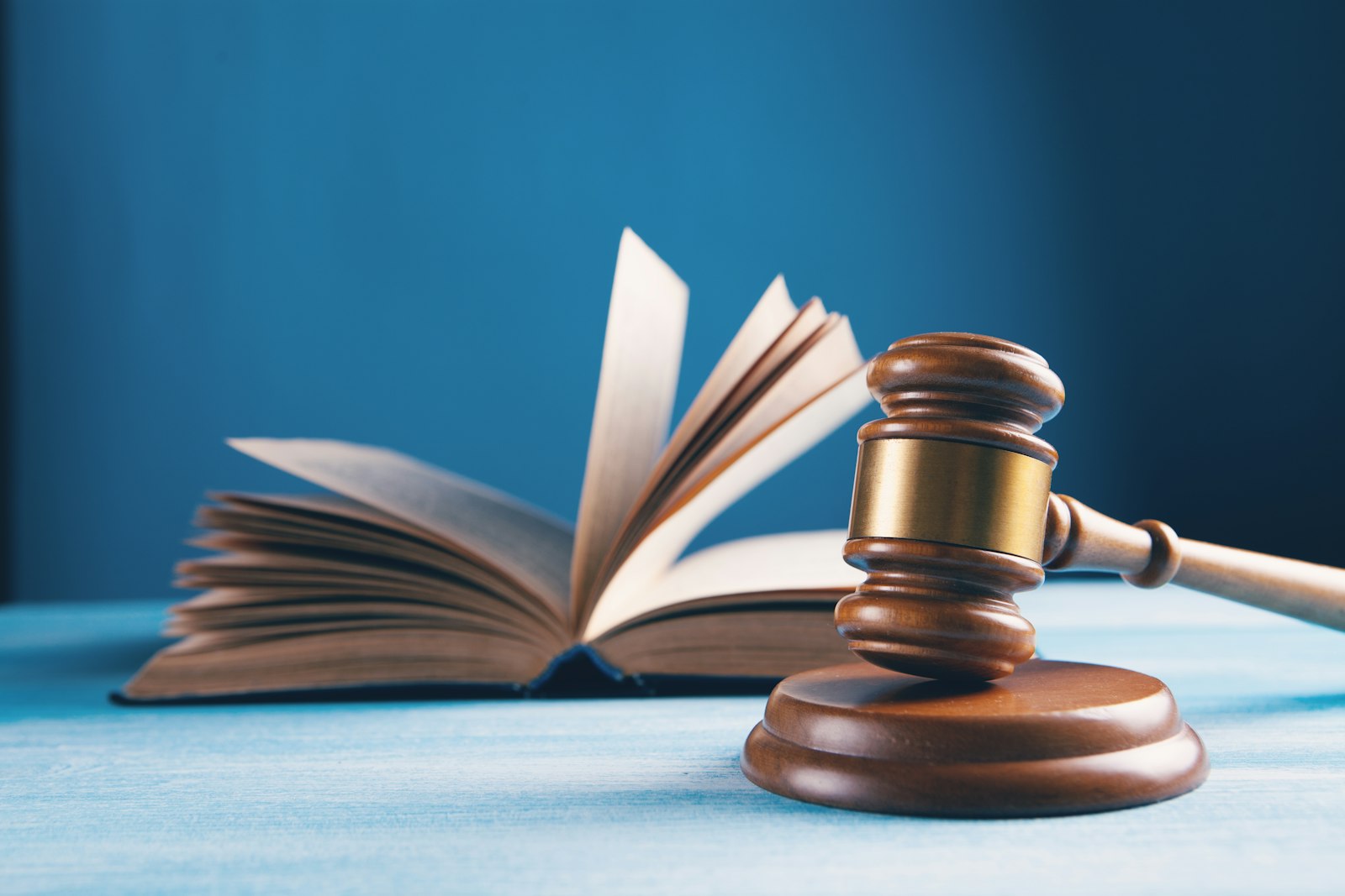 a judge's gavel and an open book on a table