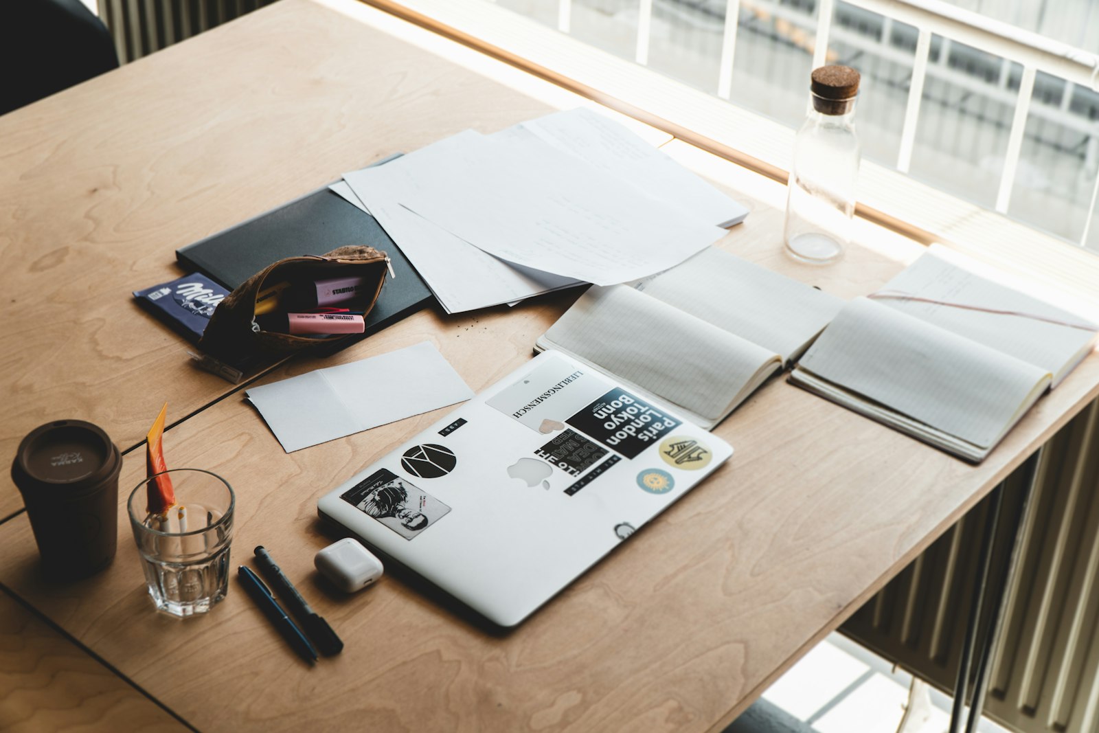 a macbook pro laptop on a brown wooden table